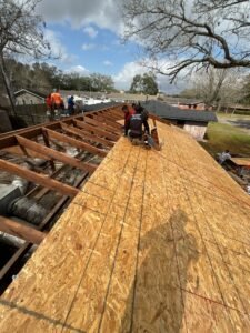 Image of a professional repairing a residential roof in Bellaire, Texas, ensuring home safety and protection from elements.