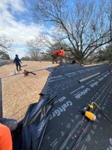 Professional roof repair service team working on a home in Bellaire, Texas, ensuring roof integrity and safety.