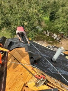 Roof repair expert inspecting a home’s roof in Atascocita, Texas, ensuring protection against weather elements.