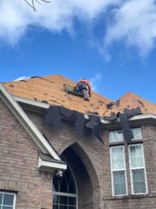 Roof repair services during work on a Houston home, showcasing essential repairs and maintenance for rooftop safety.