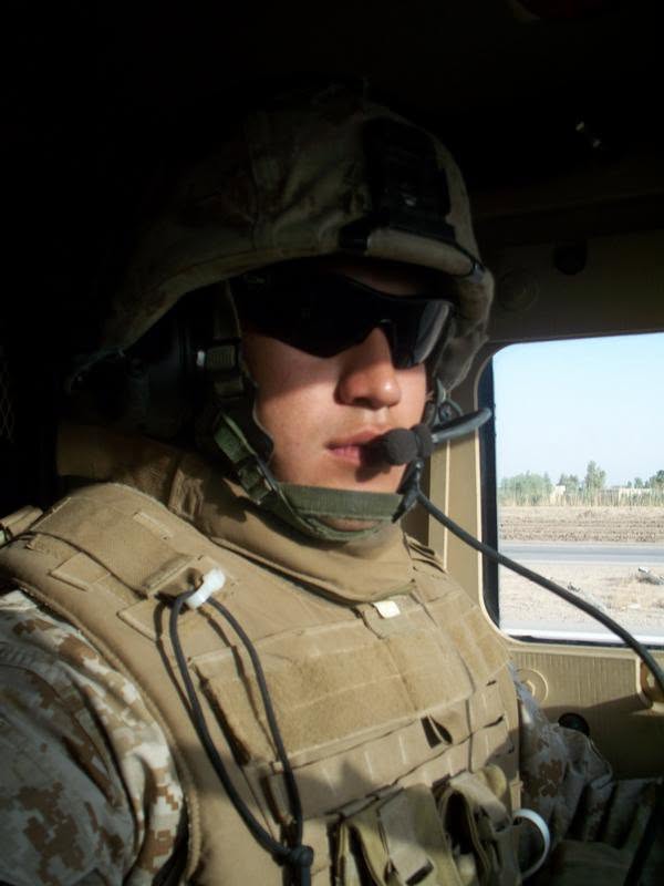 Marine in full kit inside an armored vehicle during a convoy in Iraq