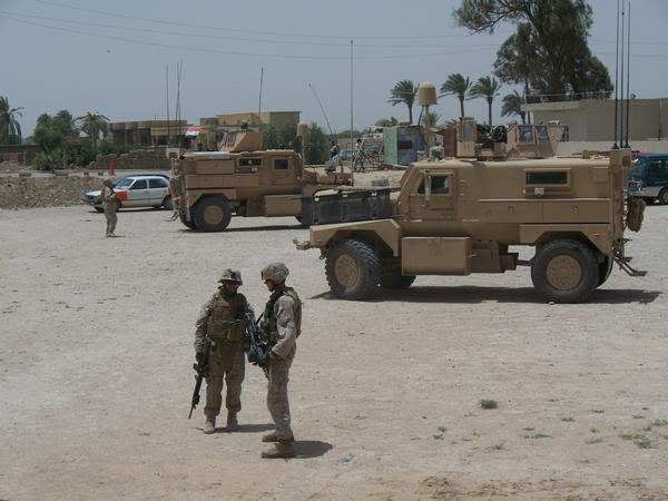 Armored vehicles staged in an Iraqi village during a security patrol
