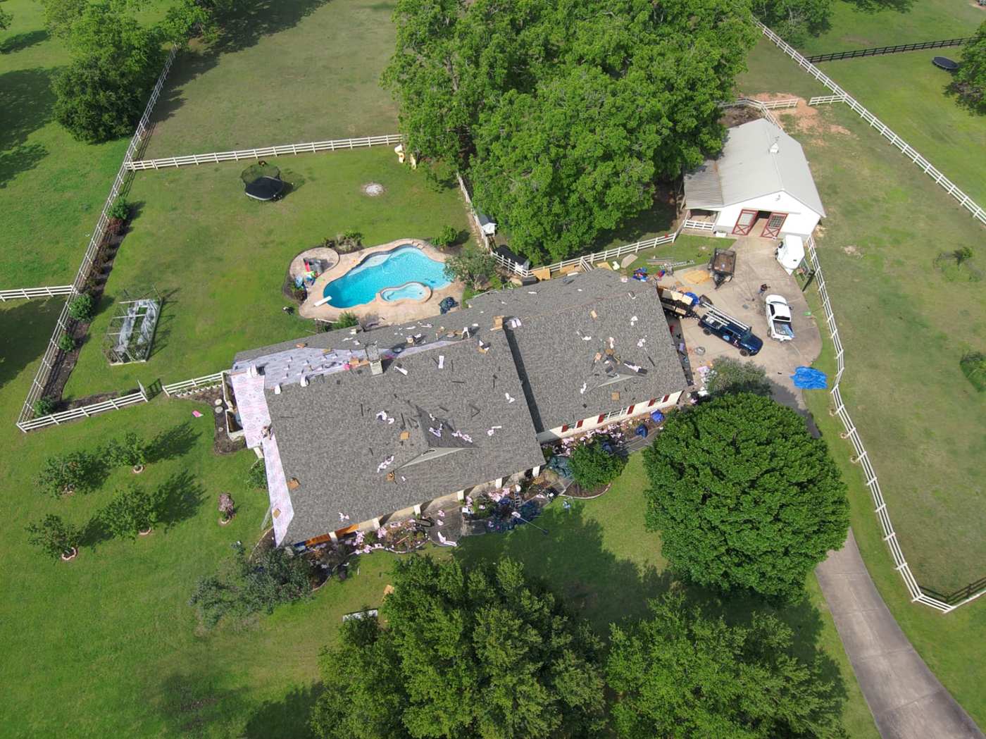 Aerial view of a country property roof with synthetic underlayment partially installed