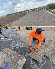 Roofer using nail gun on new shingles