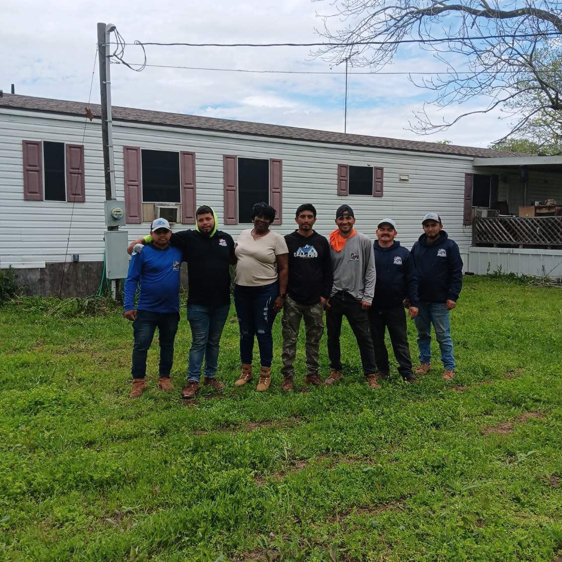 Roof Repair Services crew completing a free roof installation for a Houston-area family in need — community give-back program