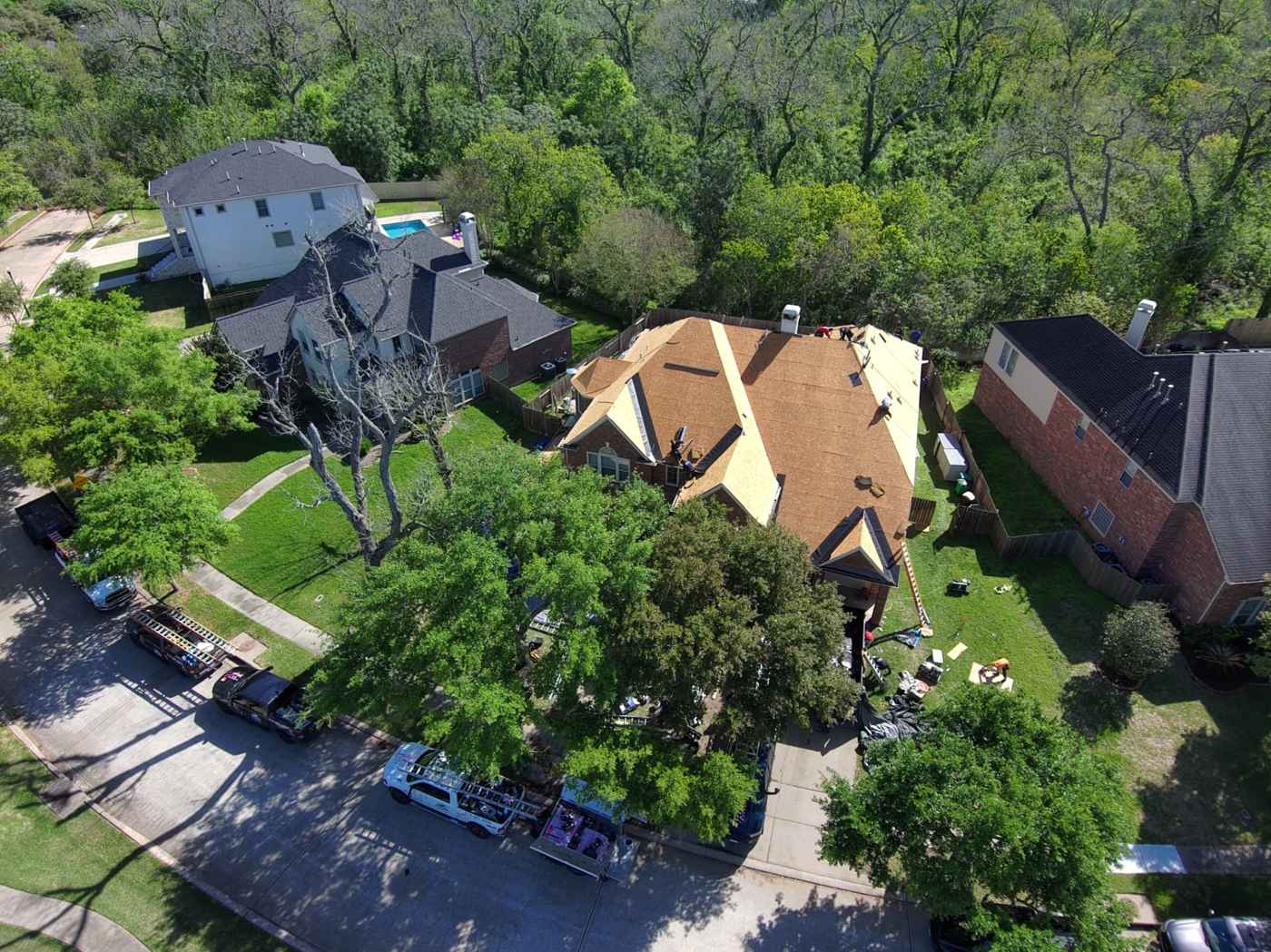 Aerial view of a Houston-area home opened down to the decking during a roof repair